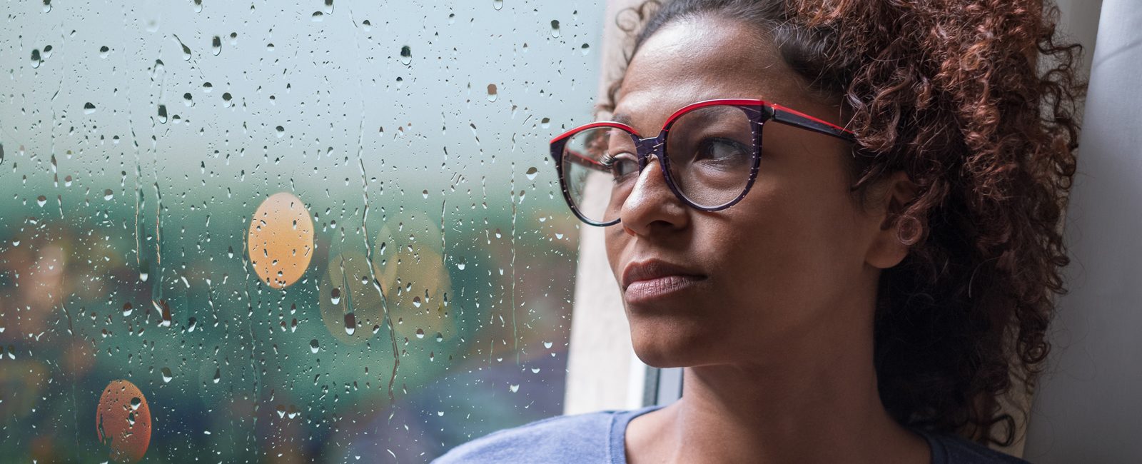Stock woman looking out window