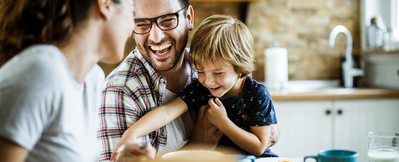 Stock young family at table
